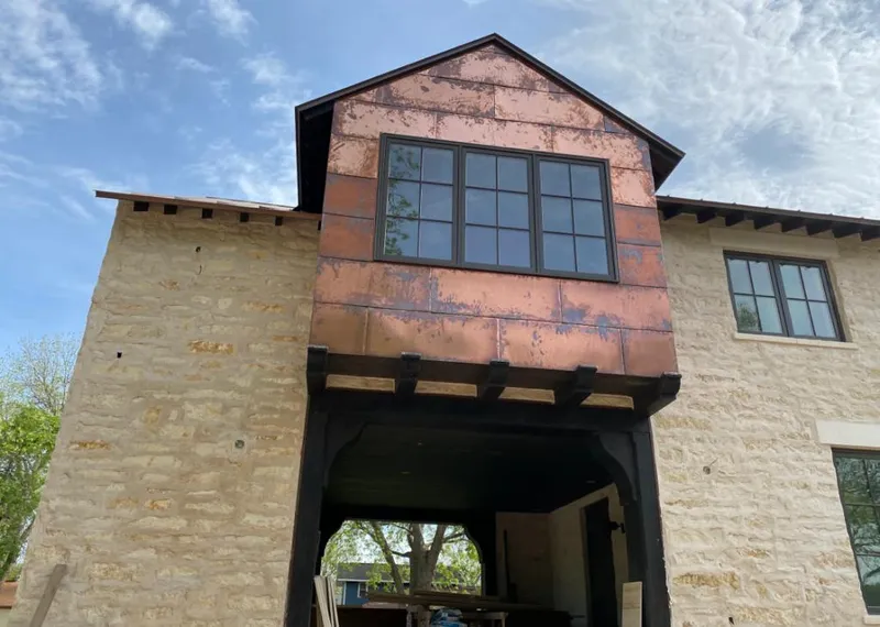 Copper metal panel facade on a stone building for Metal Roof Coating in Washington